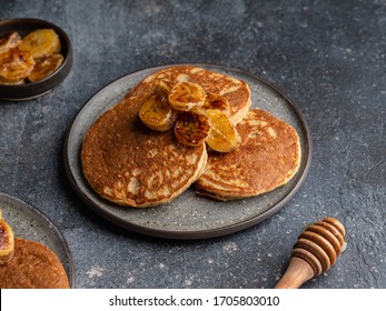 Oatmeal Banana Pancakes With Honey And Babana Slices On Ceramic Plate. Healthy Easy Making Morning Breakfast. Homemade Sugar Free And Gluten Free Food. Concrete Background, Top View. Copy Space.