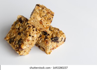 Oatmeal Bars Flapjacks Close Up Macro Shot With Nuts And Fruit And Seeds On White Background