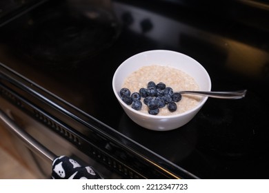 Oatmeal With Blueberries On Top Of Electric Stove Top