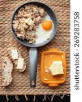 oatmeal breakfast with scrambled eggs and bread and butter on the table