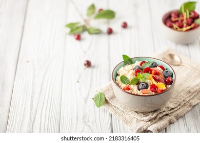 Oatmeal cereal with berries in a bowl on the table. A healthy breakfast. Baby food. - Powered by Shutterstock