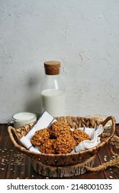 The oatmeal cookies, healthy breakfast cereal oat crackers and milk. Crispy anzac biscuit cookie with oat flakes on rustic table