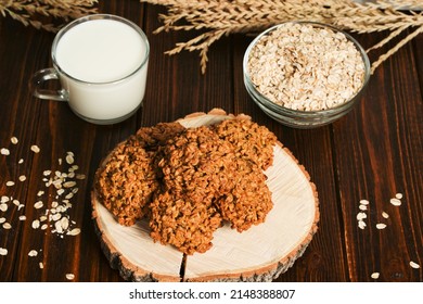 The oatmeal cookies, healthy breakfast cereal oat crackers and milk. Crispy anzac biscuit cookie with oat flakes on rustic table