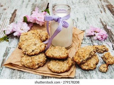 Oatmeal Cookies And  Milk On A Old Wooden Background