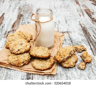 Oatmeal Cookies And  Milk On A Old Wooden Background