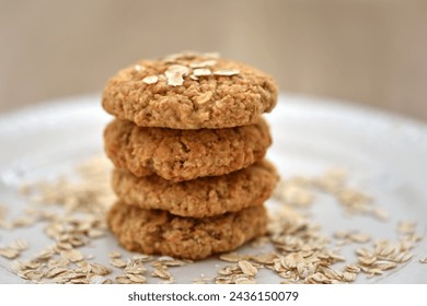 Oatmeal cookies with oat flakes on a white plate. Healthy food for breakfast or a snack. Side view. Soft focus - Powered by Shutterstock