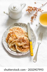 Oatmeal Mini Crepes Without Flour With Apple Cinnamon Sauce And Green Tea On A Light Background, Top View