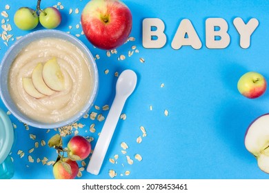 Oatmeal Porridge For A Baby From Ground Cereals In A Bowl, Ripe Red Apples, A Spoon, The Word 