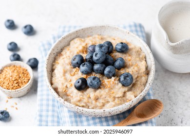Oatmeal porridge with blueberries and flax seeds. Healthy vegan breakfast