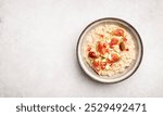 Oatmeal porridge with figs, nuts and pomegranate, top view, copy space