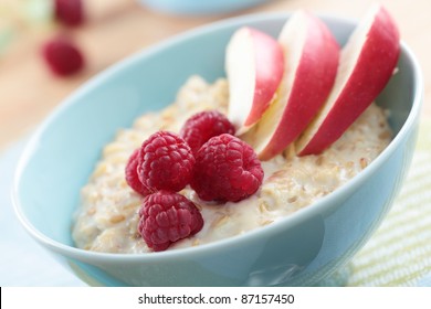 Oatmeal porridge with raspberry and apple in a bowl - Powered by Shutterstock