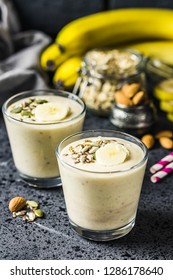 Oats Banana Almond Milk Shake With Nuts And Seeds On Dark Background. Selective Focus, Space For Text.