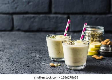 Oats Banana Almond Milk Shake With Nuts And Seeds On Dark Background. Selective Focus, Space For Text.