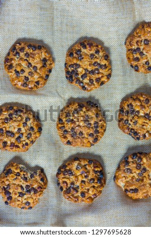 oats cookies with hazelnuts and chocolate chips on a grey cloth