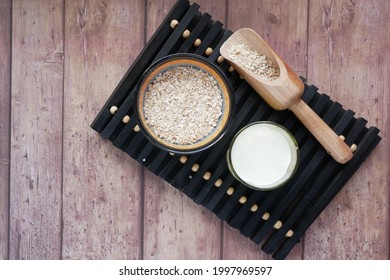 Oats Flakes And A Glass Of Milk On Wooden Background, Top Down 