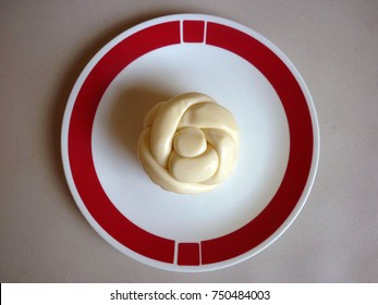 Oaxaca Cheese On A Red And White Plate