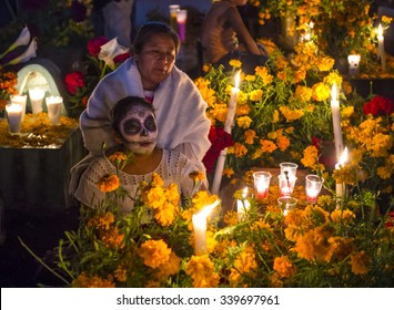 OAXACA , MEXICO - NOV 02 : Unidentified people on a cemetery during Day of the Dead in Oaxaca, Mexico on November 02 2015. The Day of the Dead is one of the most popular holidays in Mexico