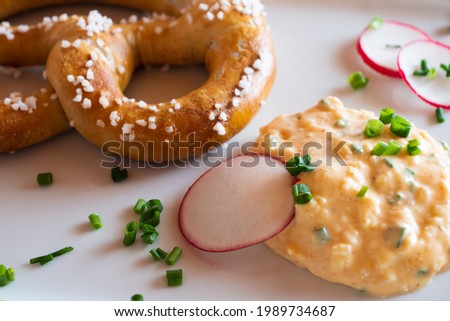 Obatzda, a Bavarian Cheese Spread also called Obatzter or Obazda with a Pretzel called Brezel or Laugenbrezel