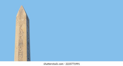 Obelisk of Theodosius (Dikilitas) with hieroglyphs in Sultanahmet Square, Istanbul, Turkey. Ancient Egyptian obelisk of Pharaoh Thutmose III. Isolated on sky blue solid background. Banner, copy space