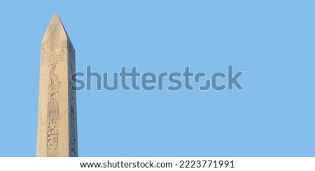 Obelisk of Theodosius (Dikilitas) with hieroglyphs in Sultanahmet Square, Istanbul, Turkey. Ancient Egyptian obelisk of Pharaoh Thutmose III. Isolated on sky blue solid background. Banner, copy space