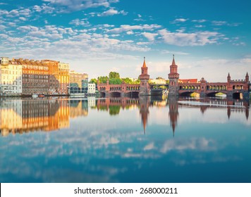 Oberbaumbruecke Berlin Summer With Reflection And Clouds