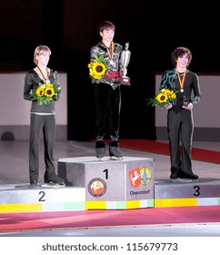 OBERSTDORF, GERMANY - SEPT 28: Winner Nobunari Oda Of Japan On The Podium, With Other Medalists, At The Medal Ceremony At Nebelhorn Trophy For Figure Skating, September 28, 2012 In Oberstdorf, Germany