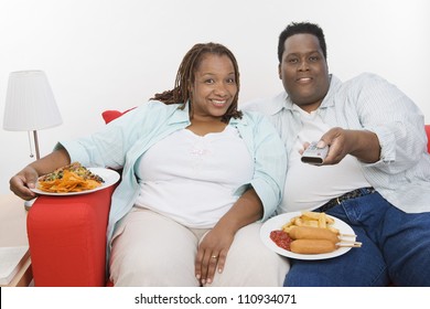 Obese African American Couple Eating Junk Food