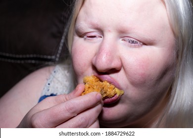 Obese, Albino Woman Eating A Chicken Tender Happily