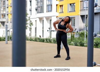 Obese Black Afro American Woman Warming Up Body Before Outdoor Running. Getting Ready For Jogging. Sport, Activity, Healthy Lifestyle And Weight Loss. Side View Portrait, Copy Space