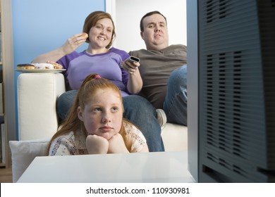 Obese Family Watching Television Together