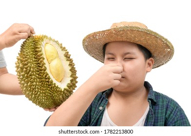 Obese fat boy with expression of disgust against fresh durian isolated on white background, Durian fruit is so smelly and pungent, good taste but bad smell. - Shutterstock ID 1782213800