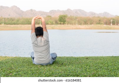 Obese Fat Boy Play Yoga Or Exercise To Lose Weight On Green Grass.