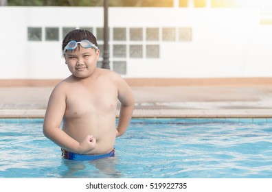 obese fat boy show muscle in swimming pool, concept healthy and exercise