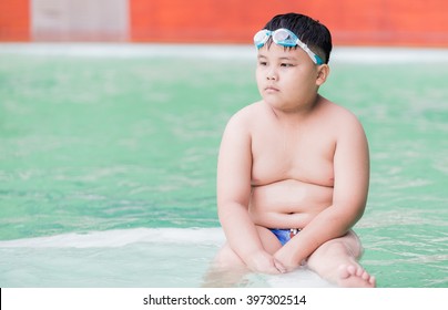 obese fat boy in swimming pool