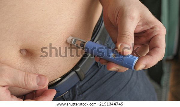 obese fat man injecting Semaglutide Ozempic\
injection control blood sugar\
levels