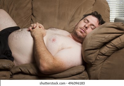 Obese Man Sleeping Heavily On The Couch