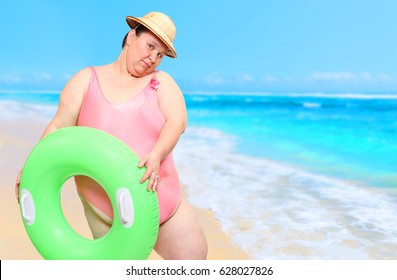 Obese woman as a coastguard with lifebuoy watching on beach. Summer in tropical paradise. Travel and insurance concept. 