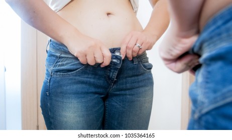 Obese Woman Dressing In Small Jeans In Fron Of Mirror