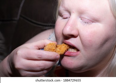 Obese Woman Eating A Chicken Tender