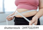 Obese Woman with fat upset about her belly. Overweight woman touching his fat belly and want to lose weight. Fat woman worried about weight diet lifestyle