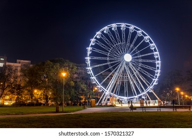 [object BRNO,  CZECH REPUBLIC - OCTOBER 22, 2019: Huge Christmas Illuminated Wheel For People With A Beautiful View Of Moravian Square In Brno Moving During A Cold Evening During The Time Lapse Video 