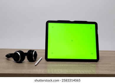 the Object Digital tablet with a Green screen and headphones in the working space