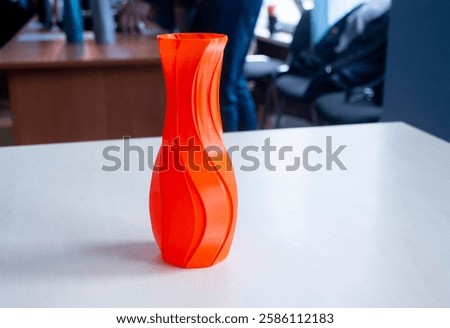 Object in the form of a vase of red color printed on a 3D printer. Three-dimensional model printed on a 3D printer from molten plastic of red color. Concept 3D Printing. FDM 3D Printing technology