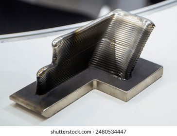 Object printed by 3D printer from metal. Additive manufacturing solution. Object created on 3Dprinter from melting metal thread. 3D Metal Printing. Metal additive manufacturing