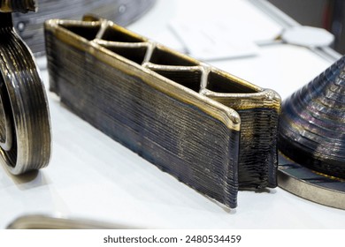 Object printed by 3D printer from metal. Additive manufacturing solution. Object created on 3Dprinter from melting metal thread. 3D Metal Printing. Metal additive manufacturing