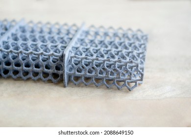 Object printed on powder 3D printer from powder polyamide. Gray object formed