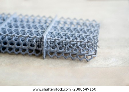 Object printed on powder 3D printer from powder polyamide. Gray object formed