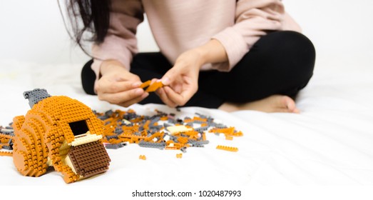The object of the tile is the color for the construction. Asian girl playing toy.