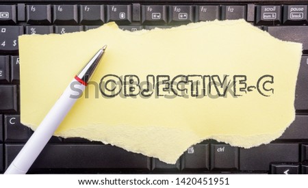 Objective-c programming language. Paper width word Objective-c and pencil on laptop keyboard