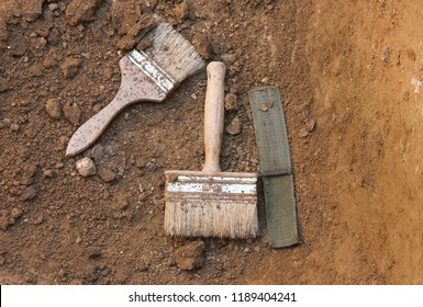 Objects of the archaeologist. Things of an archaeologist. archaeological brushes on the ground.